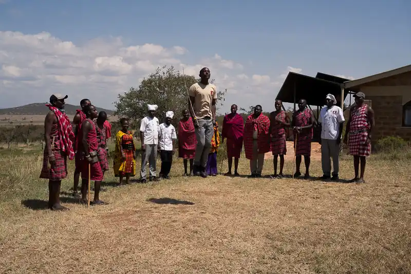 Camp staff and Maasai community welcoming guests at the safari camp