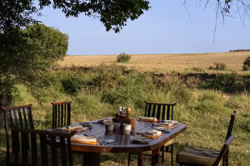 Table set for a bush meal overlooking the Maasai Mara plains