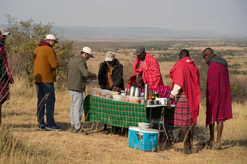 Bush coffee stop with Maasai staff and guests overlooking the plains